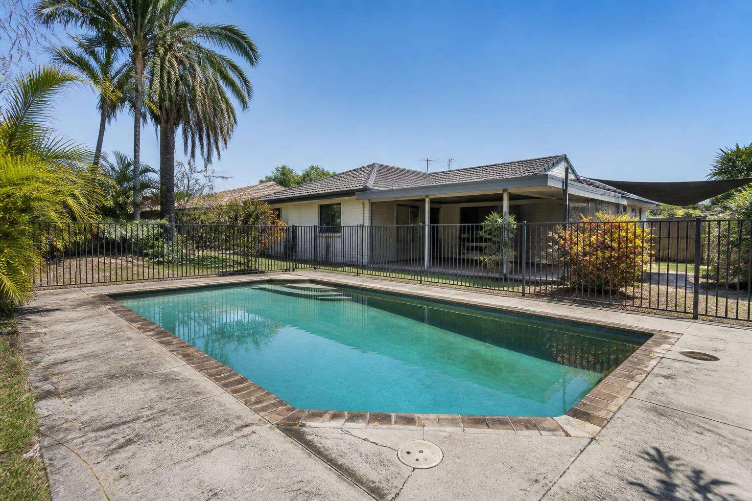 Dated concrete pool surrounds before the concept